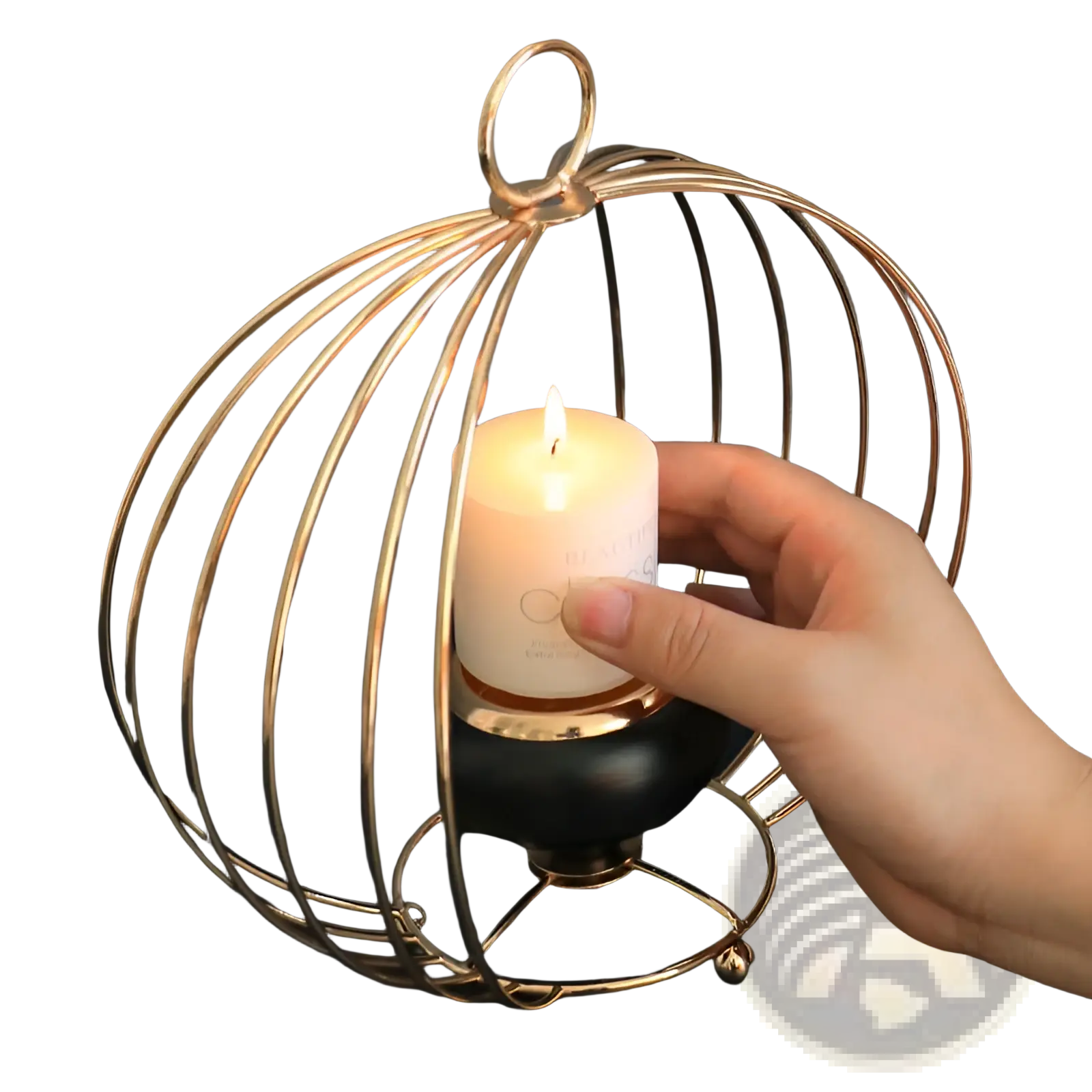 Gold geometric wire cage candle holder with black base holding a white pillar candle for decorative use