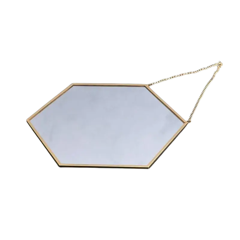 Gold hexagonal wall hanging mirror with a gold-toned metal frame and attached chain for easy mounting
