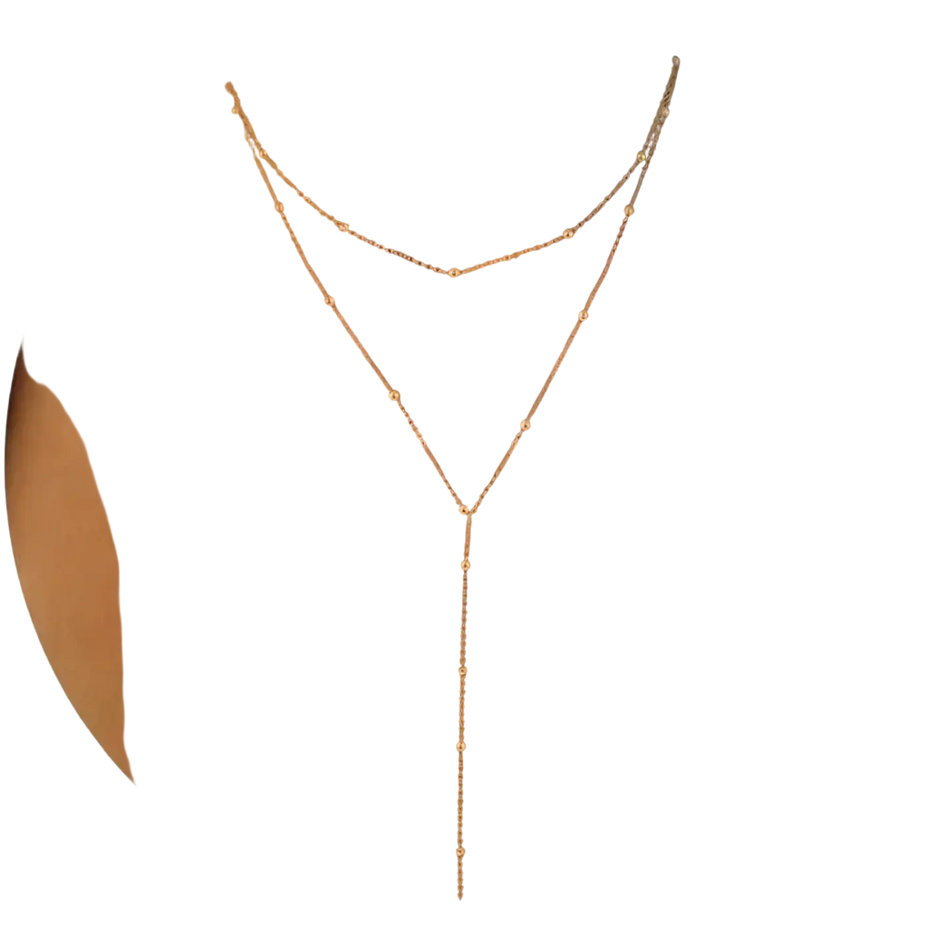 A delicate rose gold layered y necklace for women with a v-shaped design and small spherical beads along the chains
