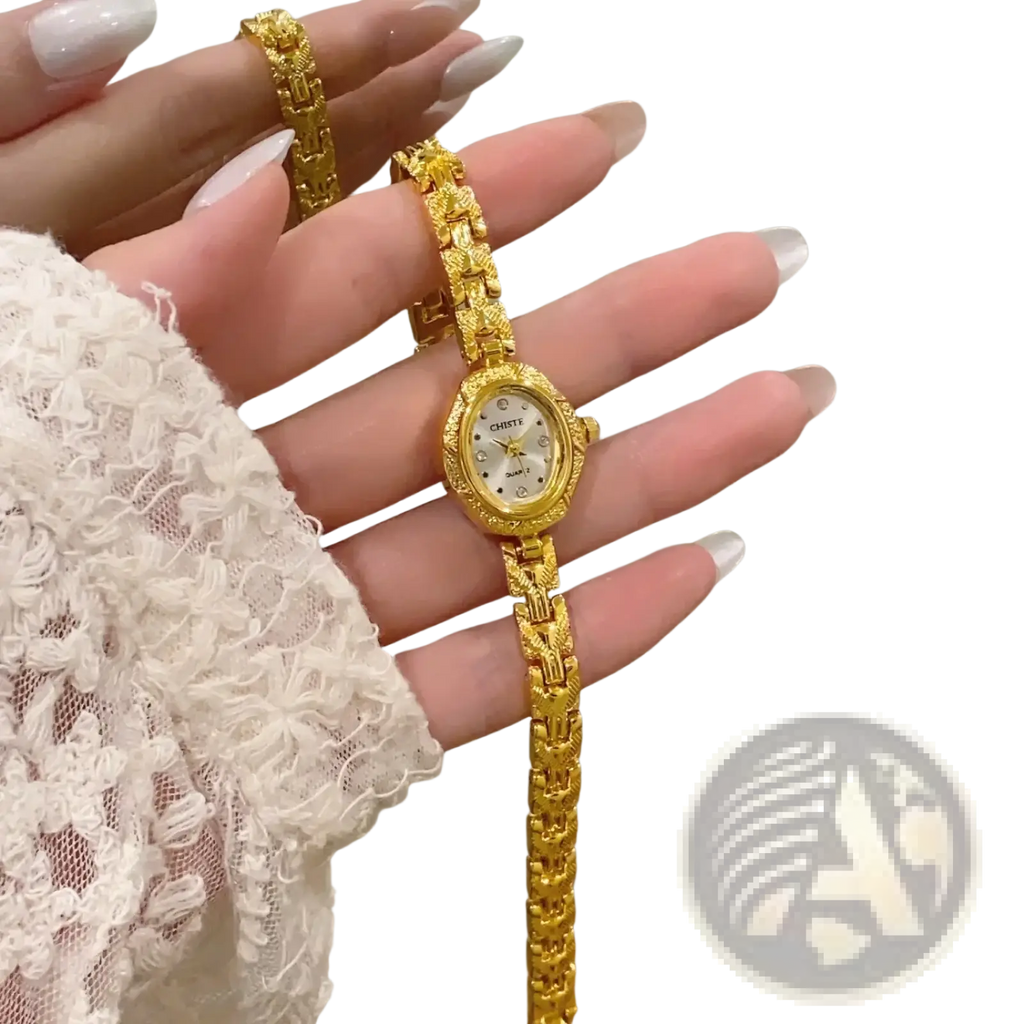 Gold luxury women’s bracelet watch with an ornate oval face and matching gold-toned chain-link band
