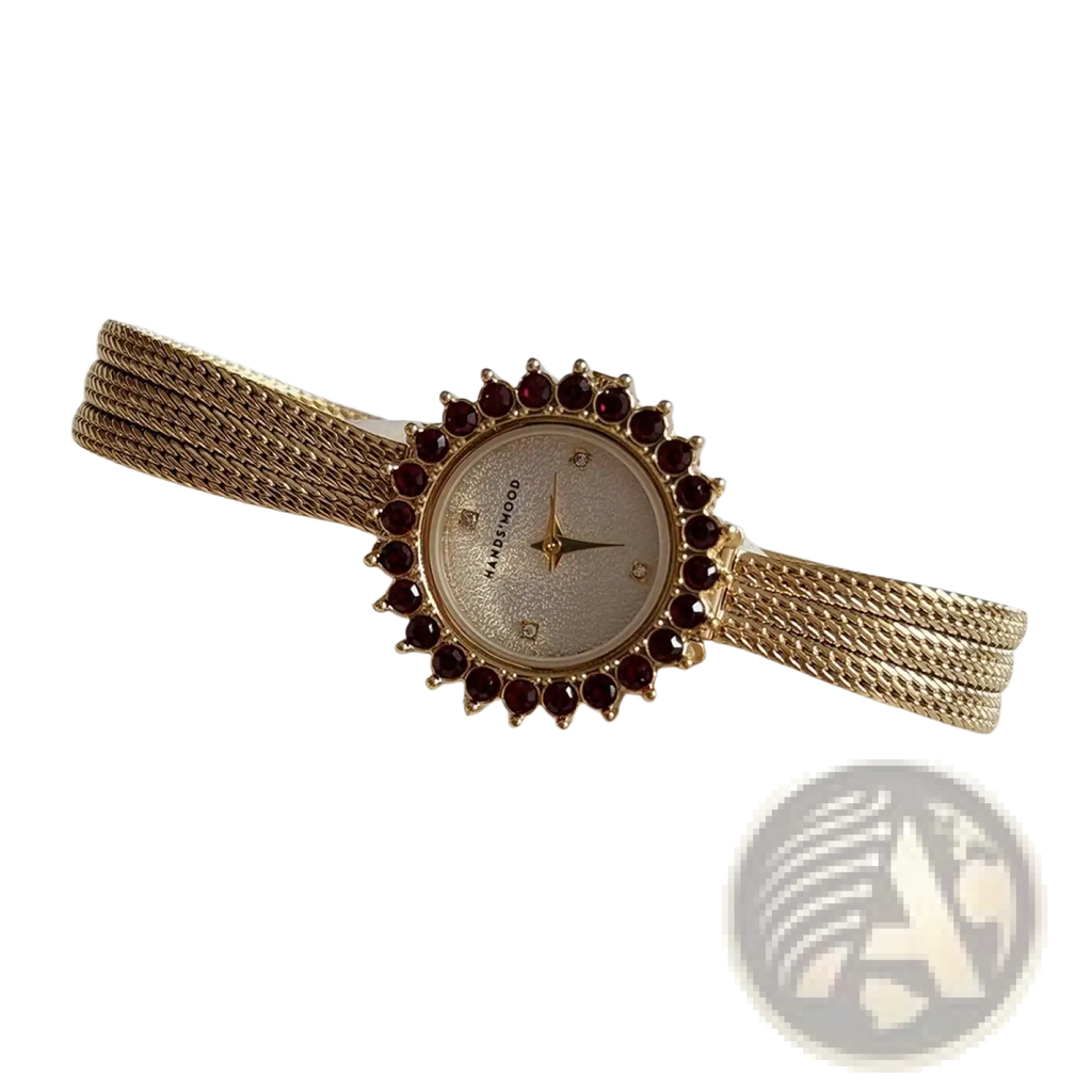 Gold mesh women watch with ruby bezel quartz movement and a circular face featuring star-shaped hands