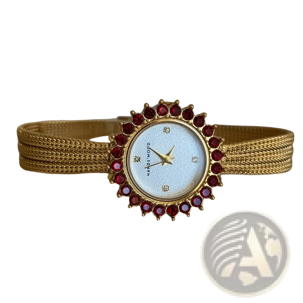 Gold mesh women watch with ruby bezel, gold-toned mesh bracelet, light blue dial, and quartz movement