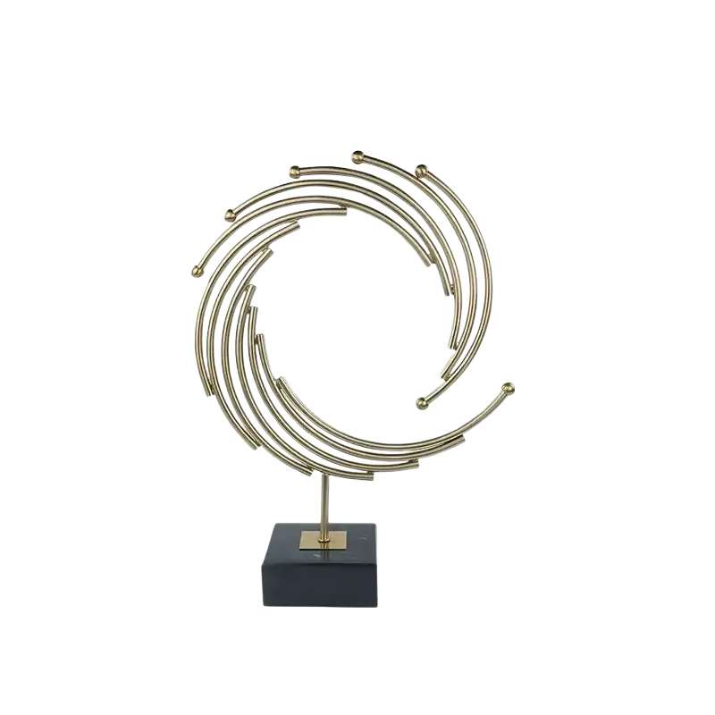 Gold metal abstract sculpture with concentric rings and spherical accents on black marble base for office desk decor