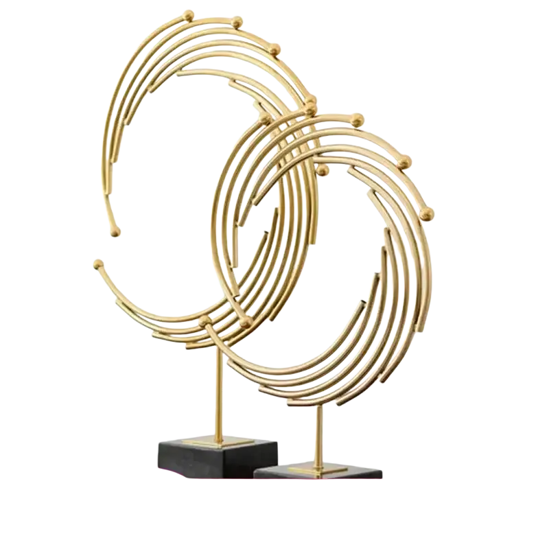 Gold metal abstract sculpture with concentric circular rings and spheres on black base for office desk decor