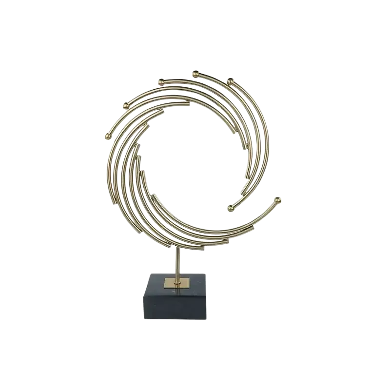 Gold metal abstract sculpture with gold-toned concentric rings and spheres on black marble base for office desk decor