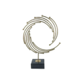 Gold metal abstract sculpture with gold-toned concentric rings and spheres on black marble base for office desk decor