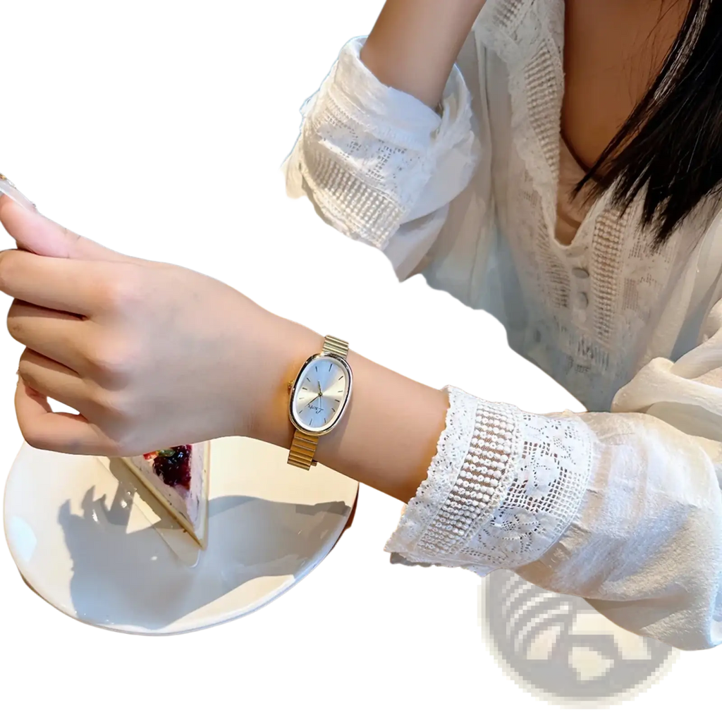 Gold minimalist oval quartz watch for women with gold-toned rectangular dial and slender metal bracelet