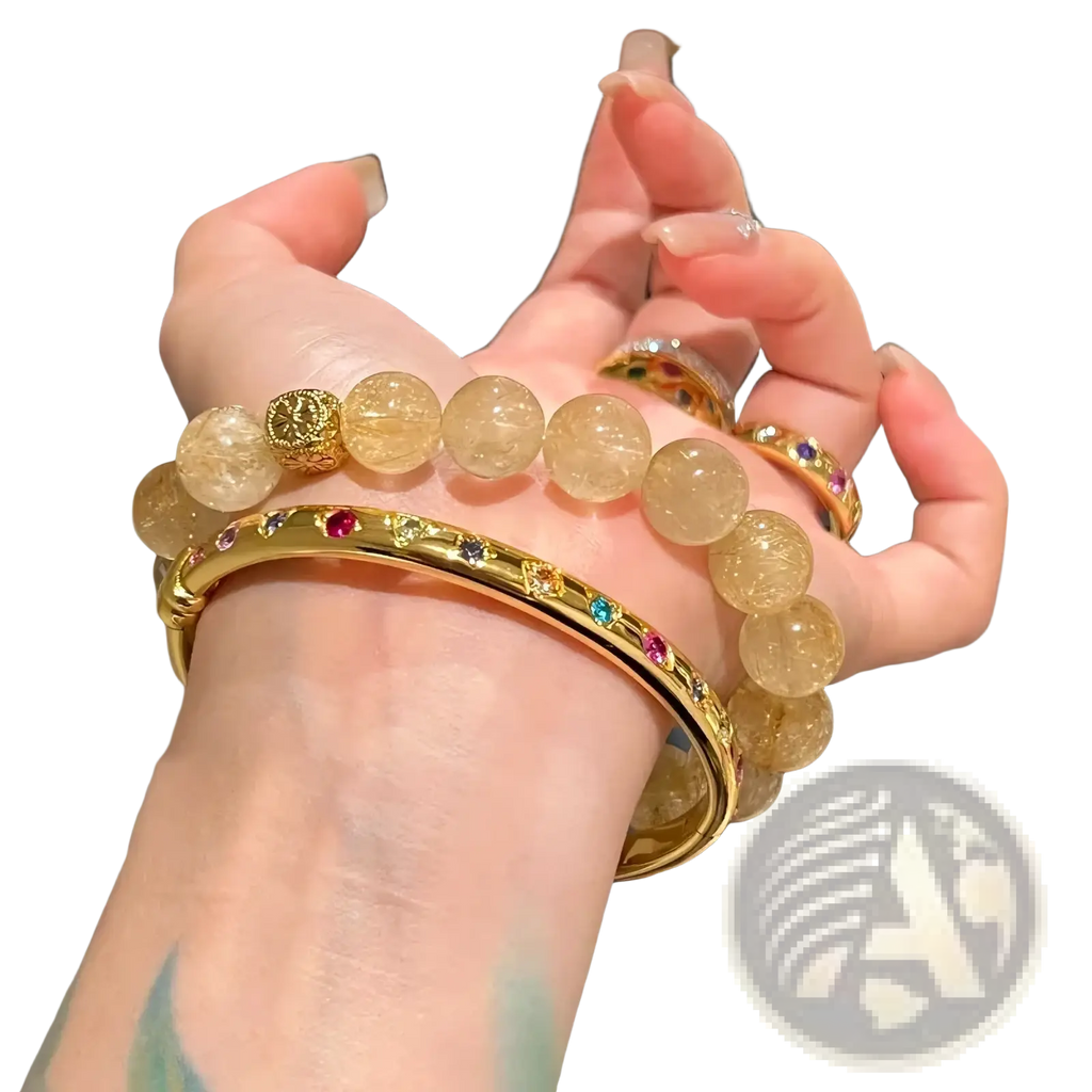 Gold multicolored gemstone bangle bracelet with gold-toned metal and a textured circular accent bead design