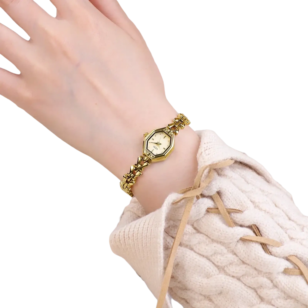 Gold-toned octagonal ladies quartz watch with matching chain bracelet worn on wrist showcasing luxury design
