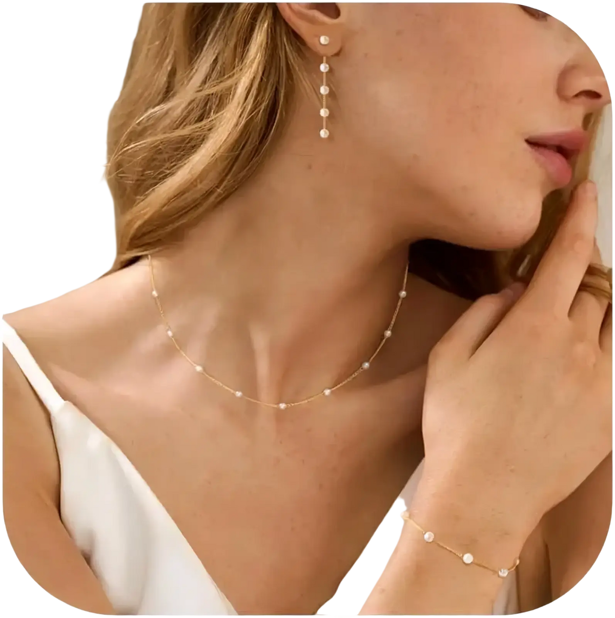 Delicate gold pearl necklace for women with fine chain and evenly spaced small white pearls in a jewelry set