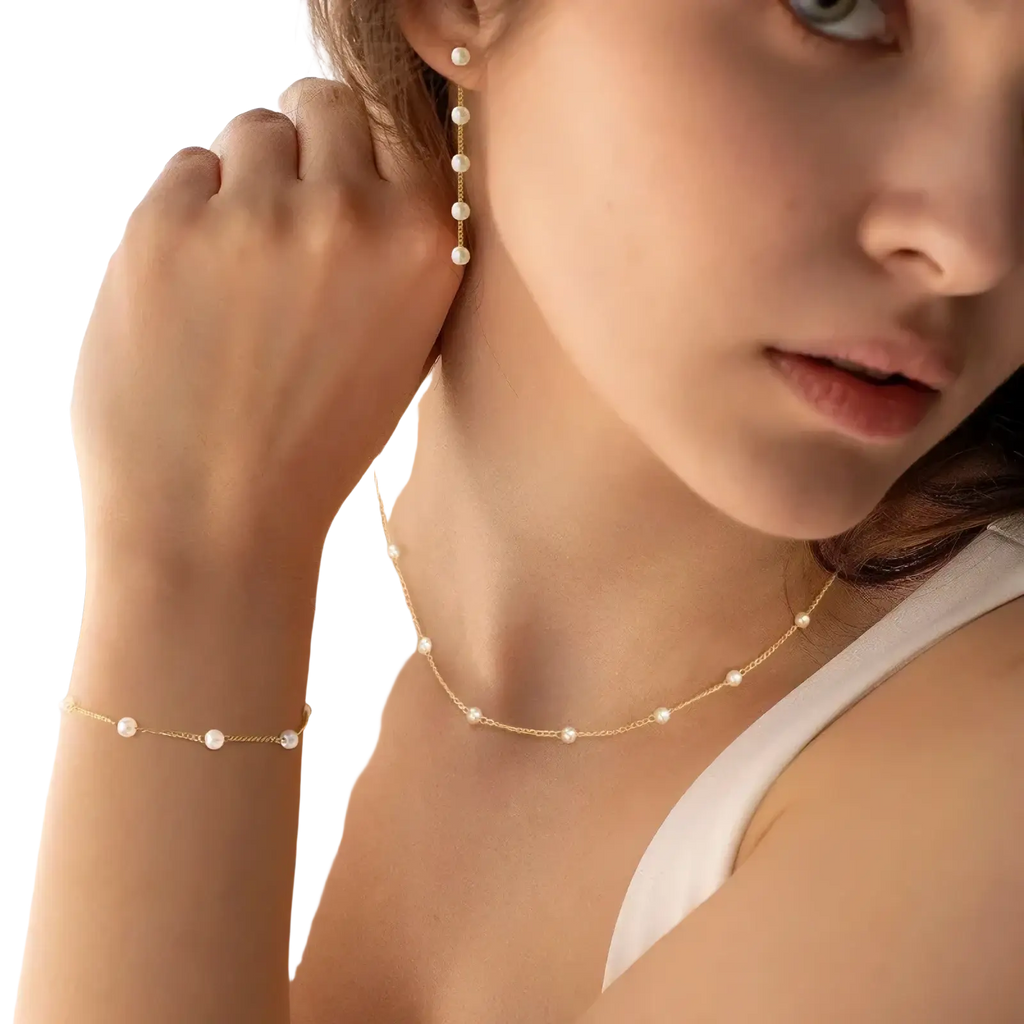 Delicate gold pearl necklace for women featuring lustrous white pearls evenly spaced on a fine chain