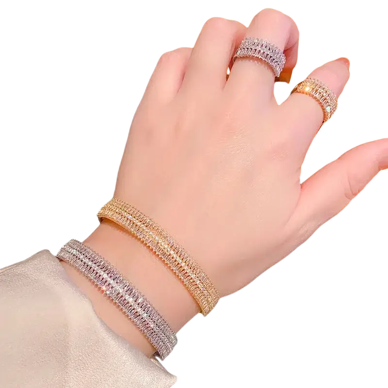 Two sparkling pave-set gold plated crystal bangle bracelets in rose gold and silver adorn the wrist