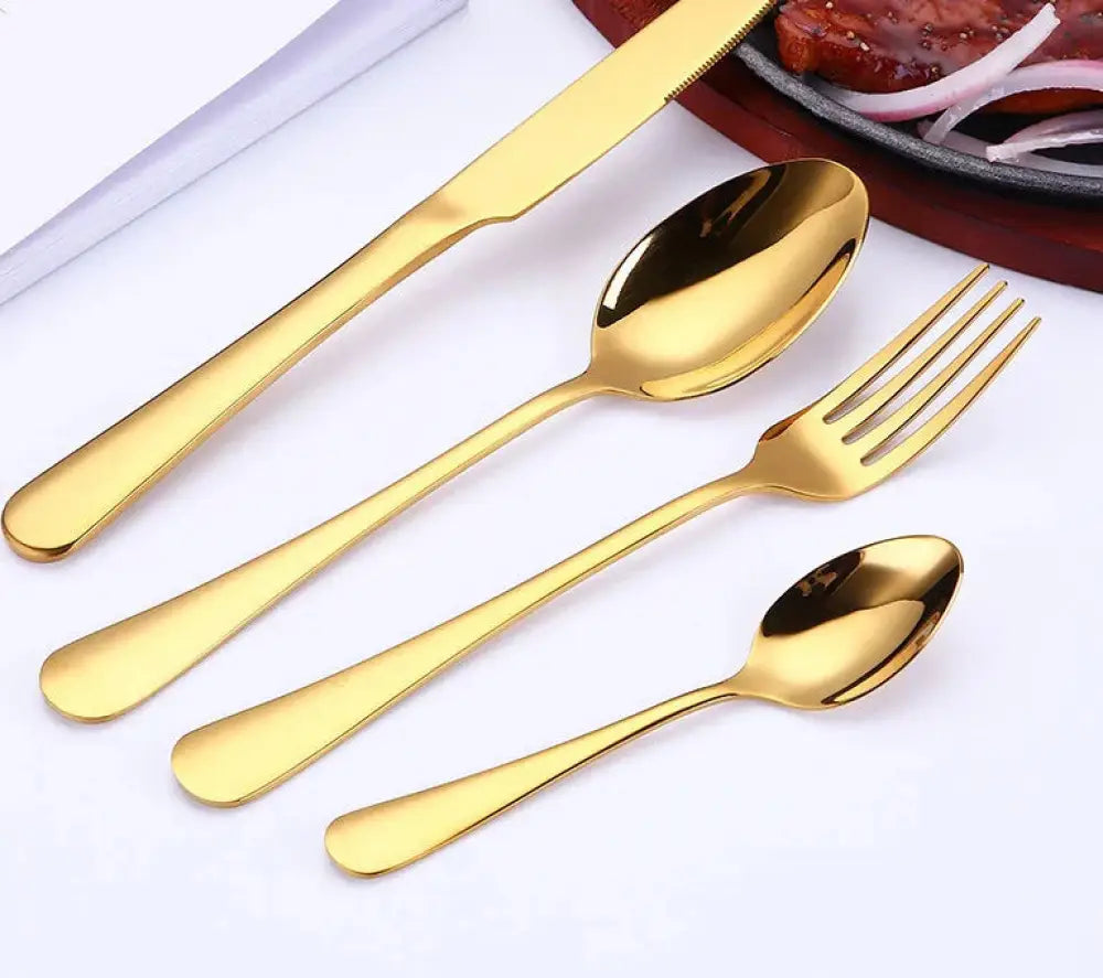 Luxury gold-plated stainless steel steak cutlery set with sleek modern design and polished reflective handles