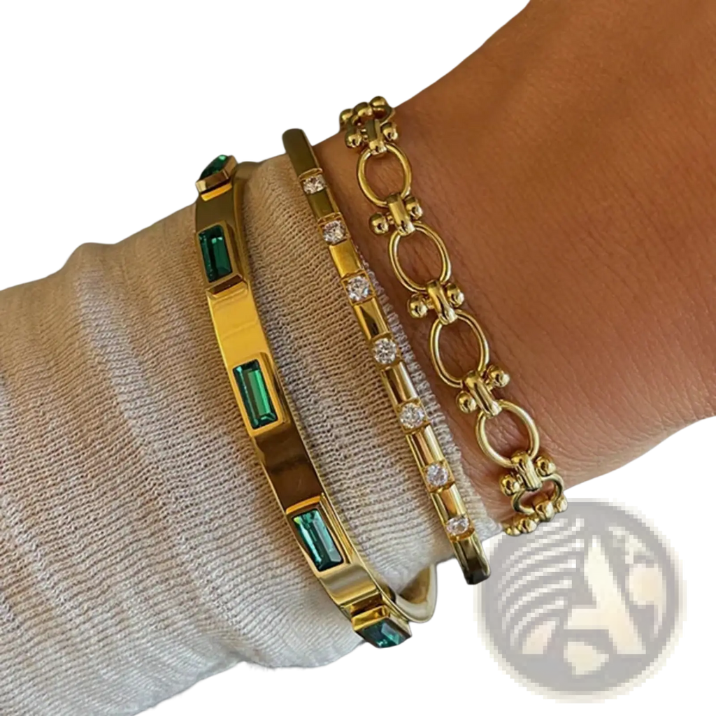 Gold plated stainless steel bangle bracelet with rectangular emerald green zirconia gemstones in a gold tone