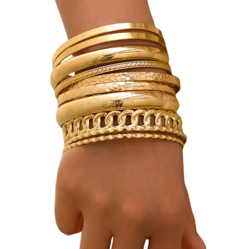 A stack of gold punk bangle bracelets featuring various textures including smooth, patterned, and chain-link styles