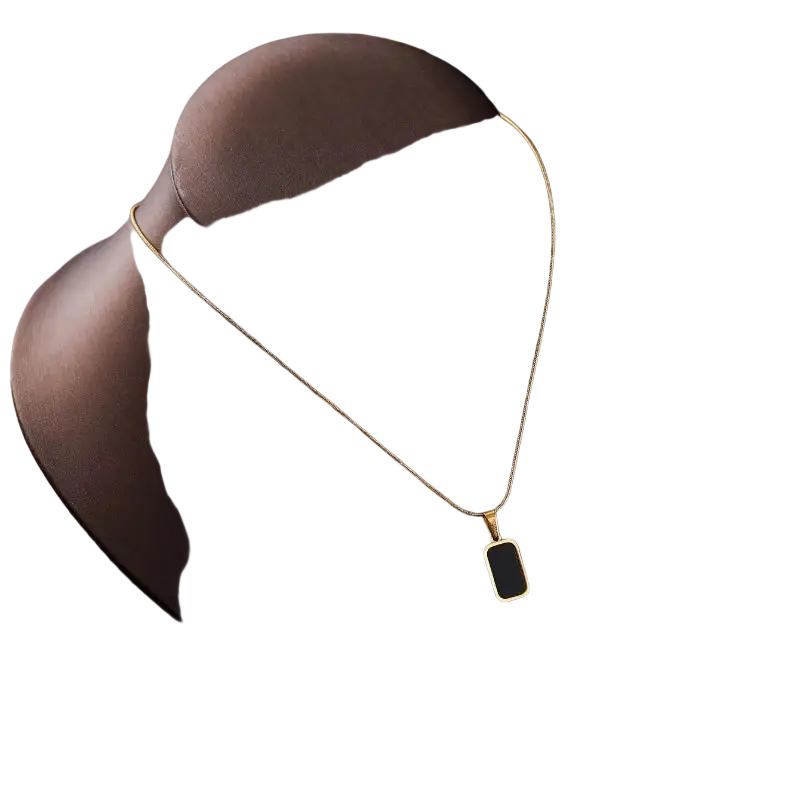 Gold rectangle pendant necklace for women with black enamel inlay displayed on a dark brown mannequin bust