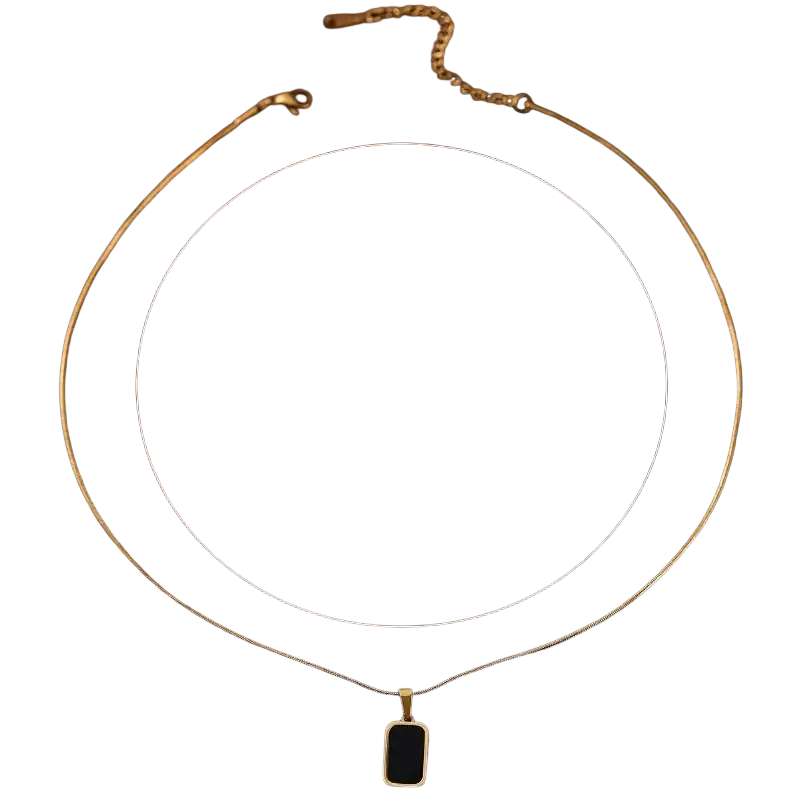 Gold-toned snake chain necklace with a rectangular black enamel pendant designed for women