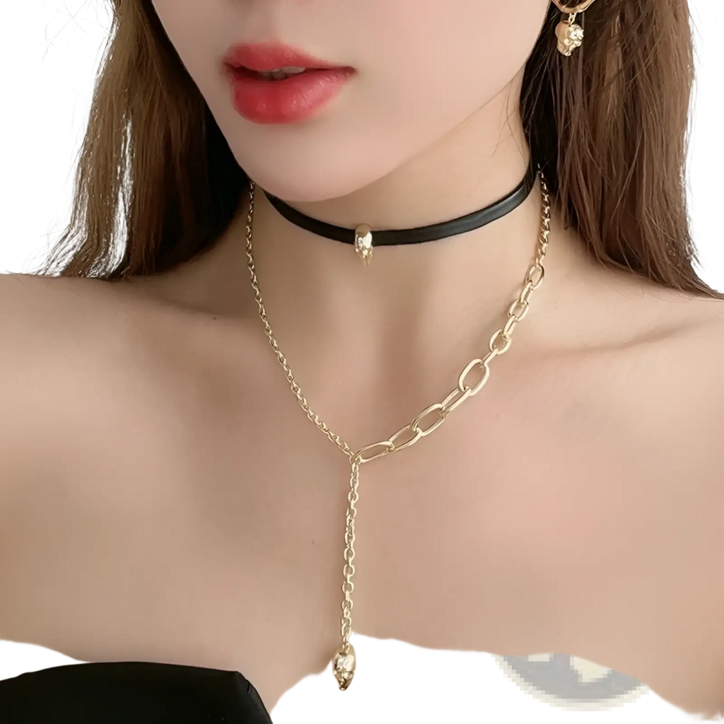 Gold-toned skull pendant necklace with layered thin choker and longer chain accented by matching skull charms