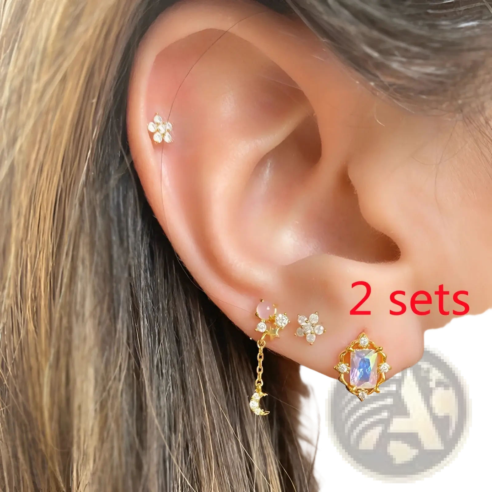 Gold-toned floral stud earrings with clear crystal accents and a dangling moon charm from the Gold Star and Moon Butterfly Earring and Cuff Set