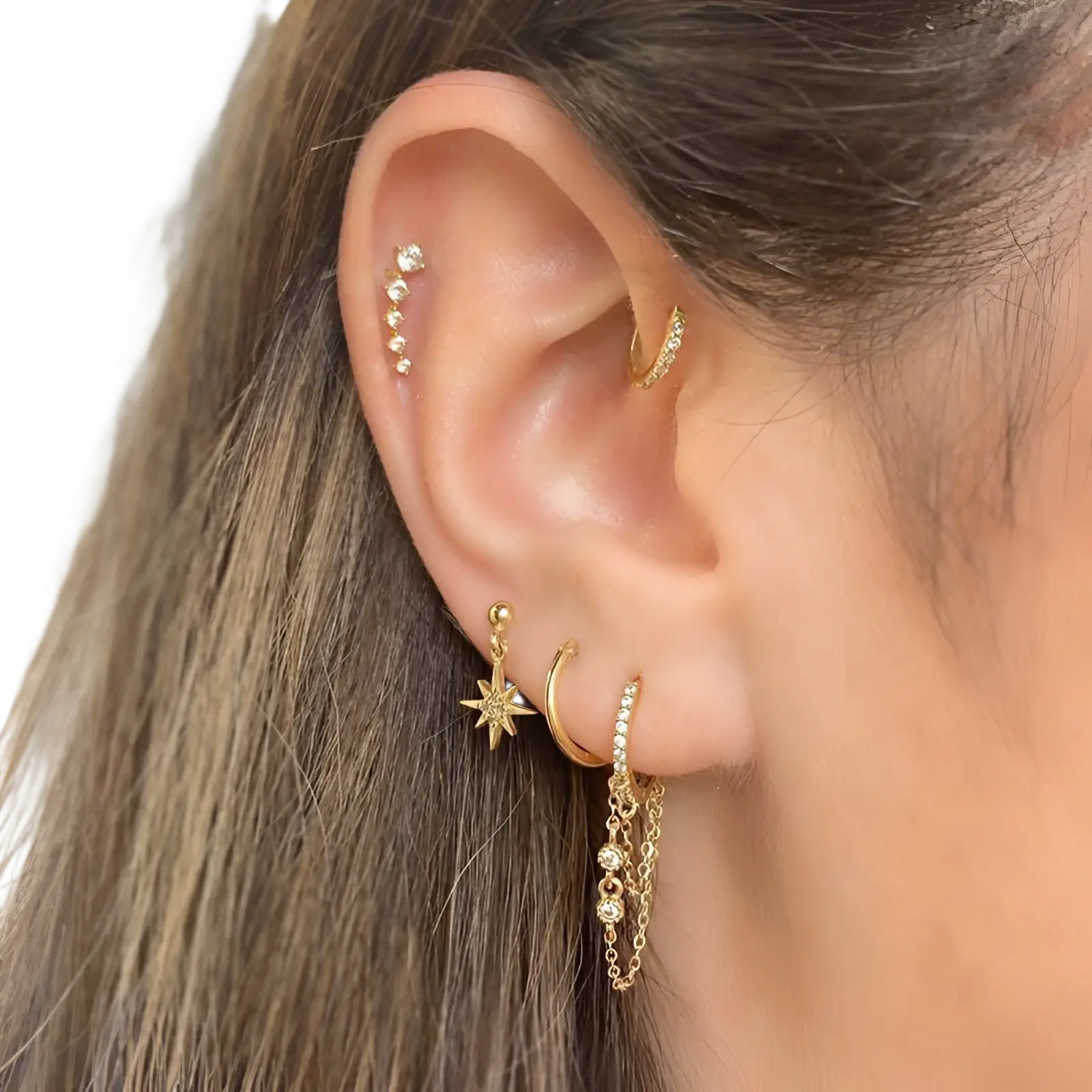 Gold star and moon butterfly earring and cuff set featuring gold-toned star dangle, beaded stud, and sparkling huggie hoops
