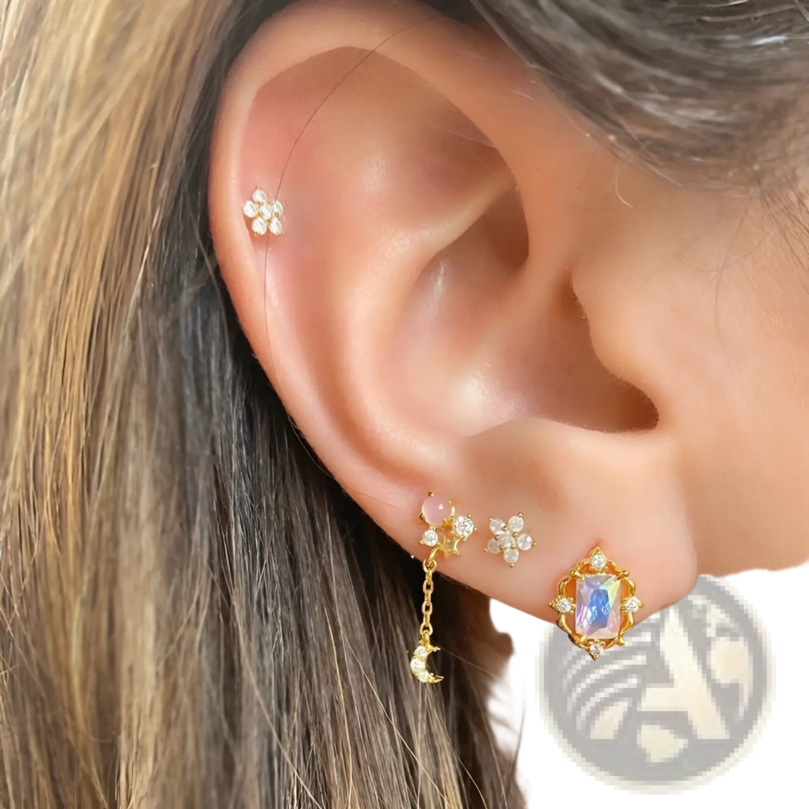 Gold star and moon butterfly earrings and cuff set featuring gold-toned floral studs with clear crystals and dangling moon charm