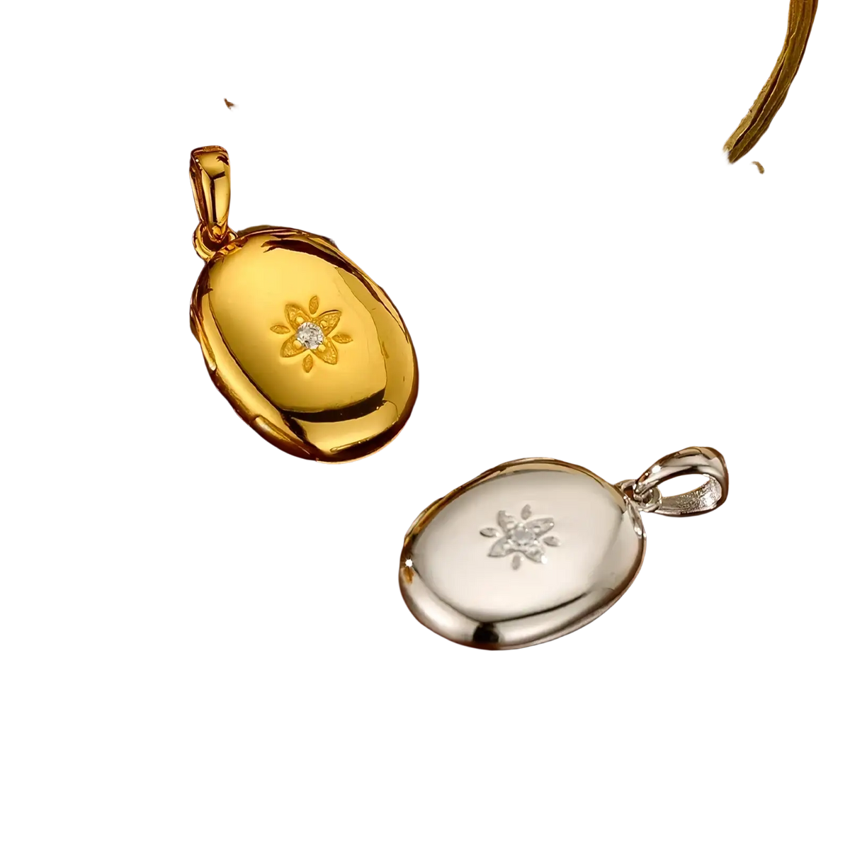 Gold starburst locket necklace featuring gold and silver oval pendants with floral engravings and central diamond accents