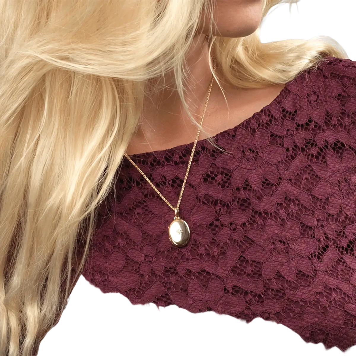 Gold starburst locket necklace with gold-toned oval pendant and delicate chain for elegant jewelry wear
