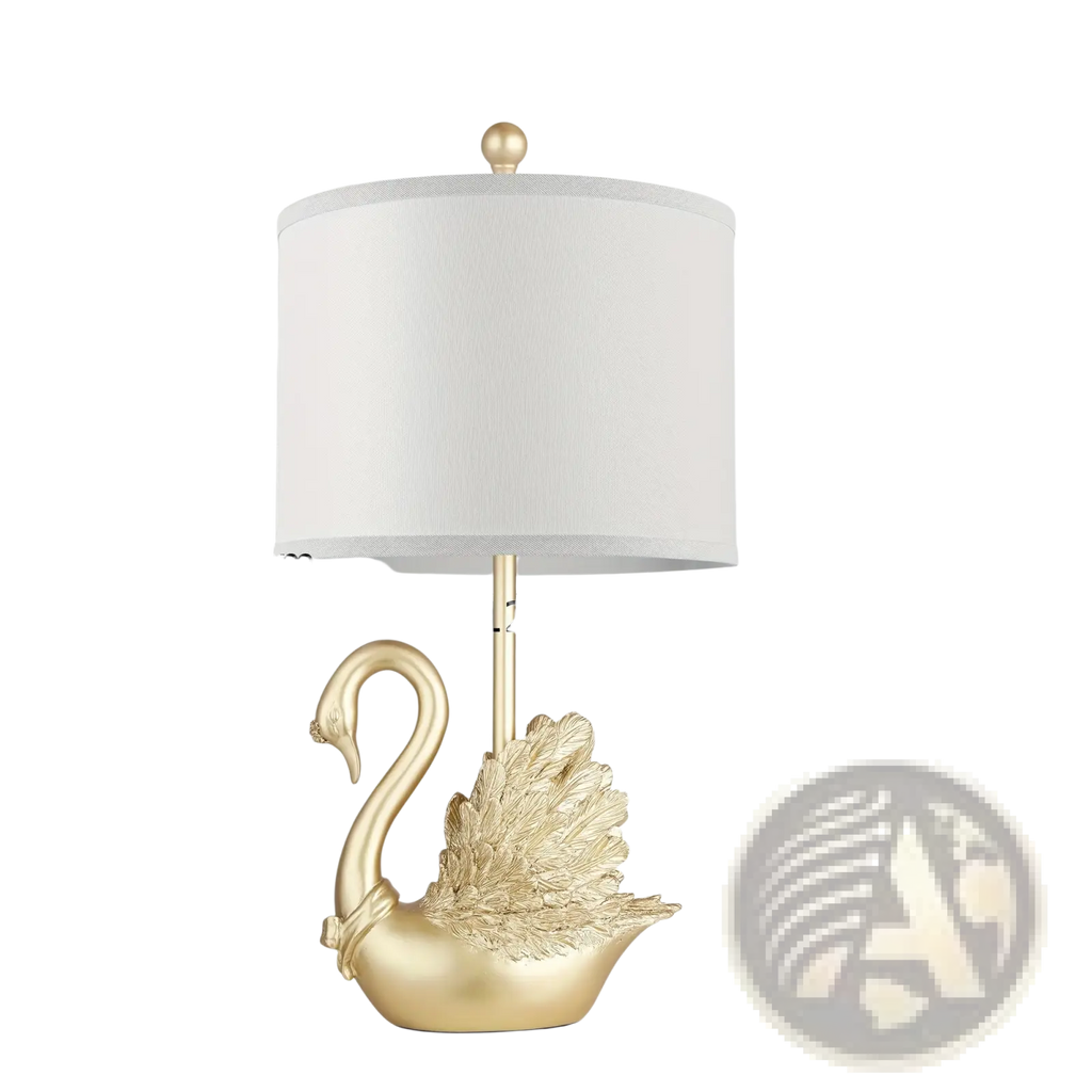 Golden swan table lamp set featuring gold-colored swan-shaped design with white fabric shade and metallic base