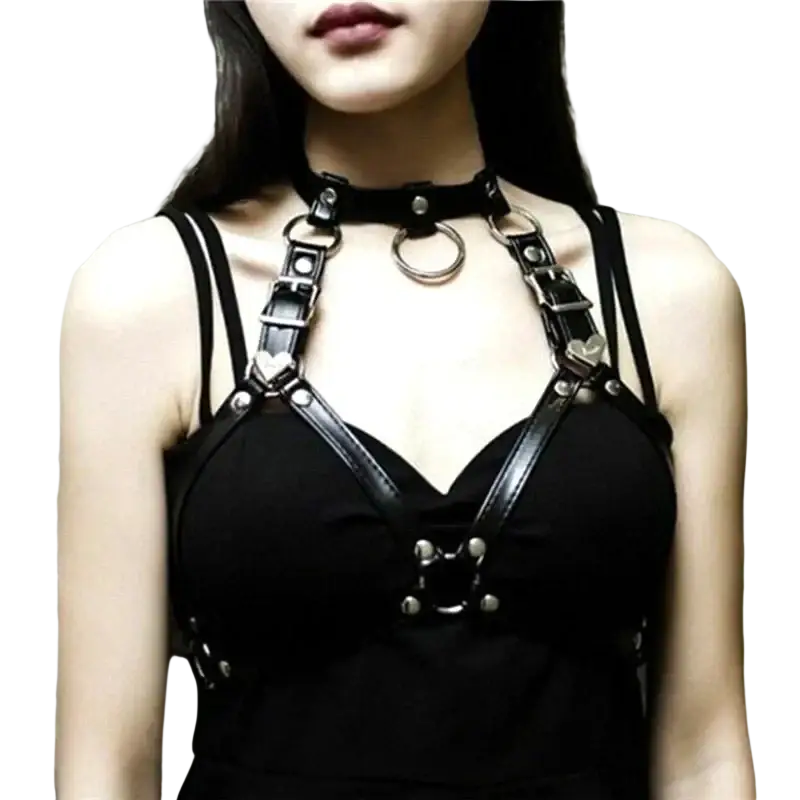 Black goth body harness faux leather chest chain with silver metal rings and heart-shaped accents as body jewelry