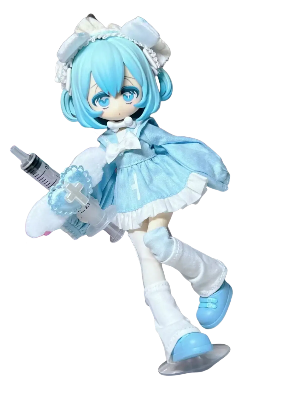 A light blue and white gothic anime collectible doll finished goods with short hair in a frilly dress holding a syringe