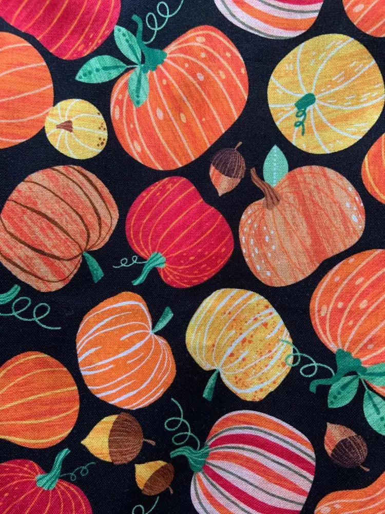 Black cotton a-line dress with vibrant orange red and yellow vintage pumpkin print and green stems gourdgeous margaret