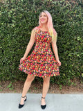 A vibrant sleeveless cotton a-line dress with orange and red pumpkin print on a dark background by Gourdgeous Margaret