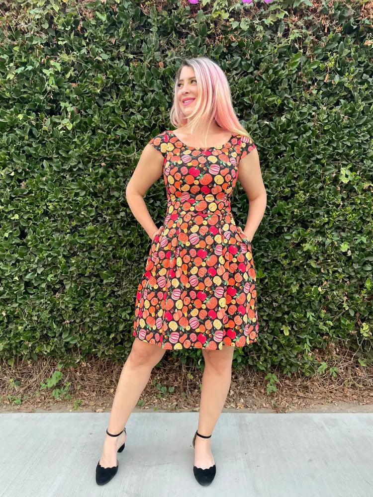 Gourdgeous Margaret vintage pumpkin print cotton a-line dress with multicolored fruit slice pattern on dark background