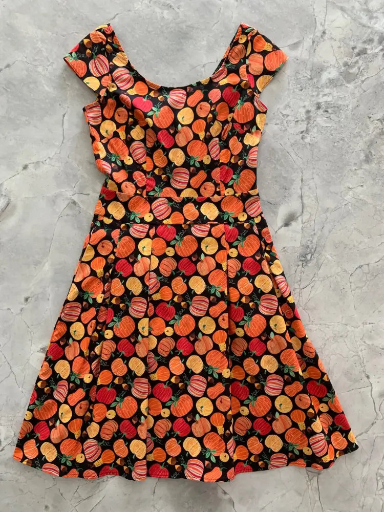 Gourdgeous Margaret vintage sleeveless cotton a-line dress with orange and red pumpkin print on black background