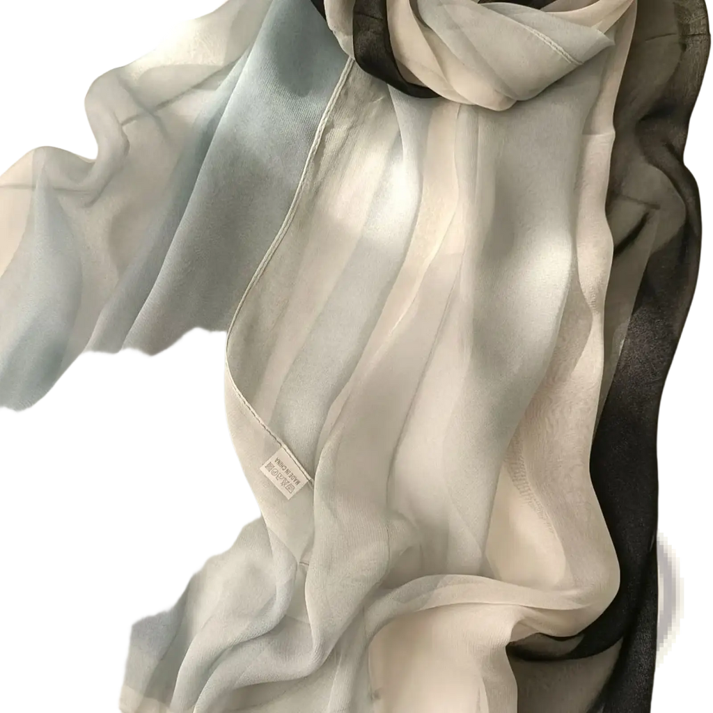 Gradient chiffon beach scarf shawl hijab with delicate sheer fabric and a soft light blue to white gradient with black edges