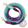 A coiled gradient dog leash braided rope training lead in teal to purple with brown leather and gold metal hardware
