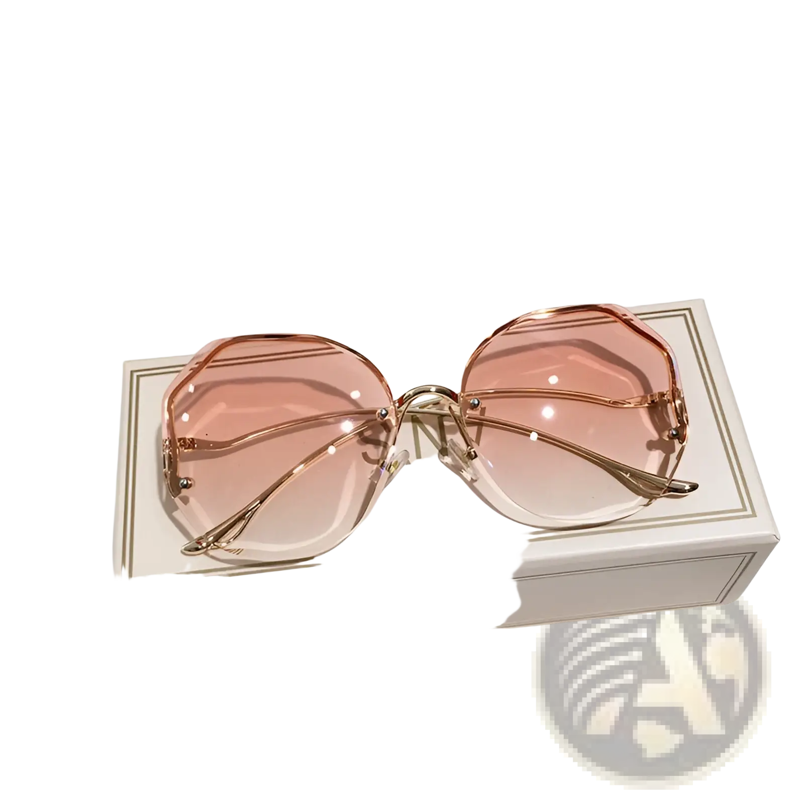 Rose gold framed oversized geometric metal sunglasses with gradient pink lenses resting on branded box
