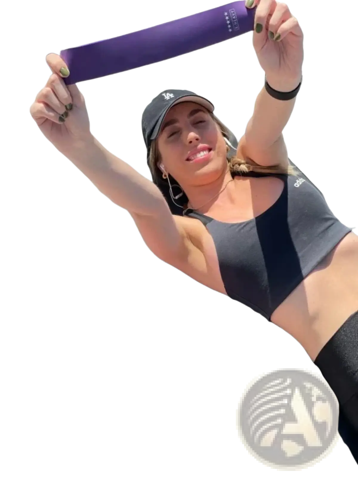 Gradient resistance bands set showing purple band held in hands with pink and orange bands laid out for workout use