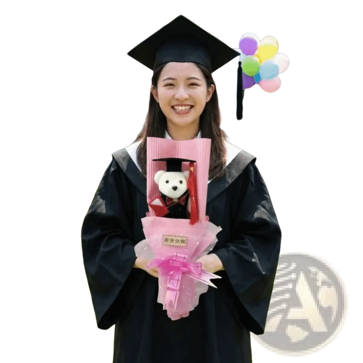 Black graduation cap with a white teddy bear in miniature gown wrapped in pink tissue from a graduation bear bouquet plush toy