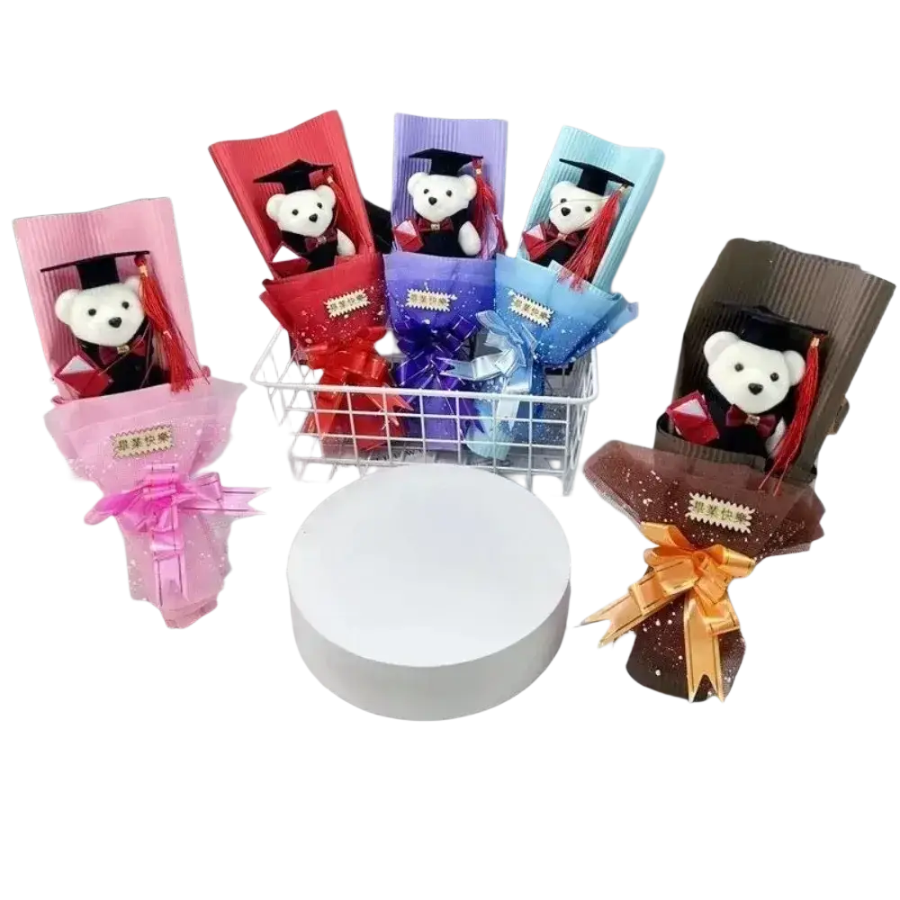 Graduation bear bouquet featuring white plush teddy bears in caps and gowns wrapped in colorful paper with ribbons
