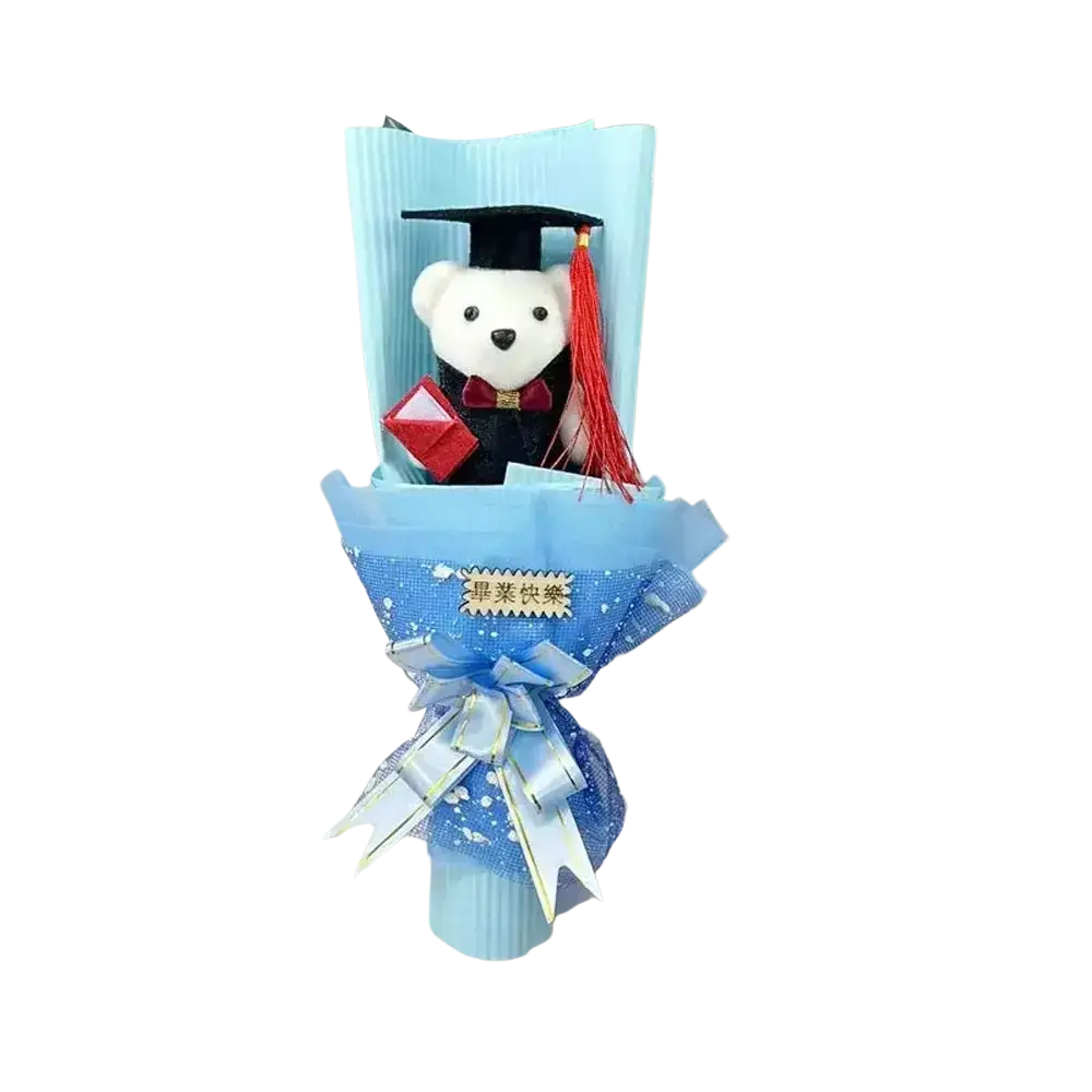A plush white graduation bear bouquet dressed in black gown with red tassel cap holding a red diploma wrapped in blue paper