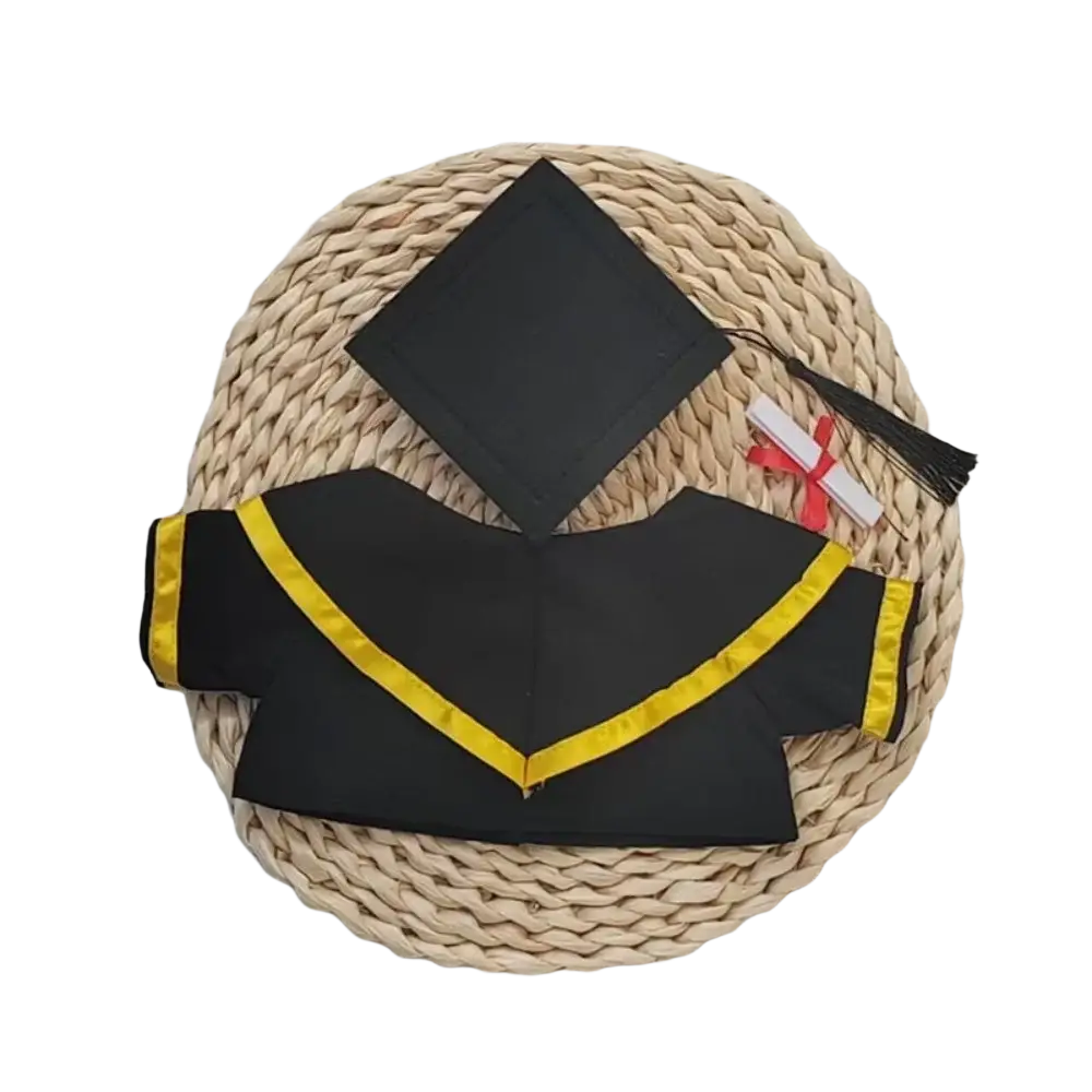 Black graduation cap and gown with yellow trim made for graduation bear suit 30cm plush doll displayed on woven mat