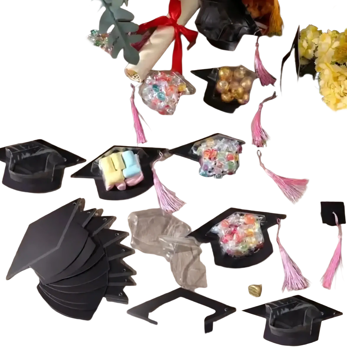 Black graduation cap candy holders with pink tassels and clear bags filled with colorful candies for party favors