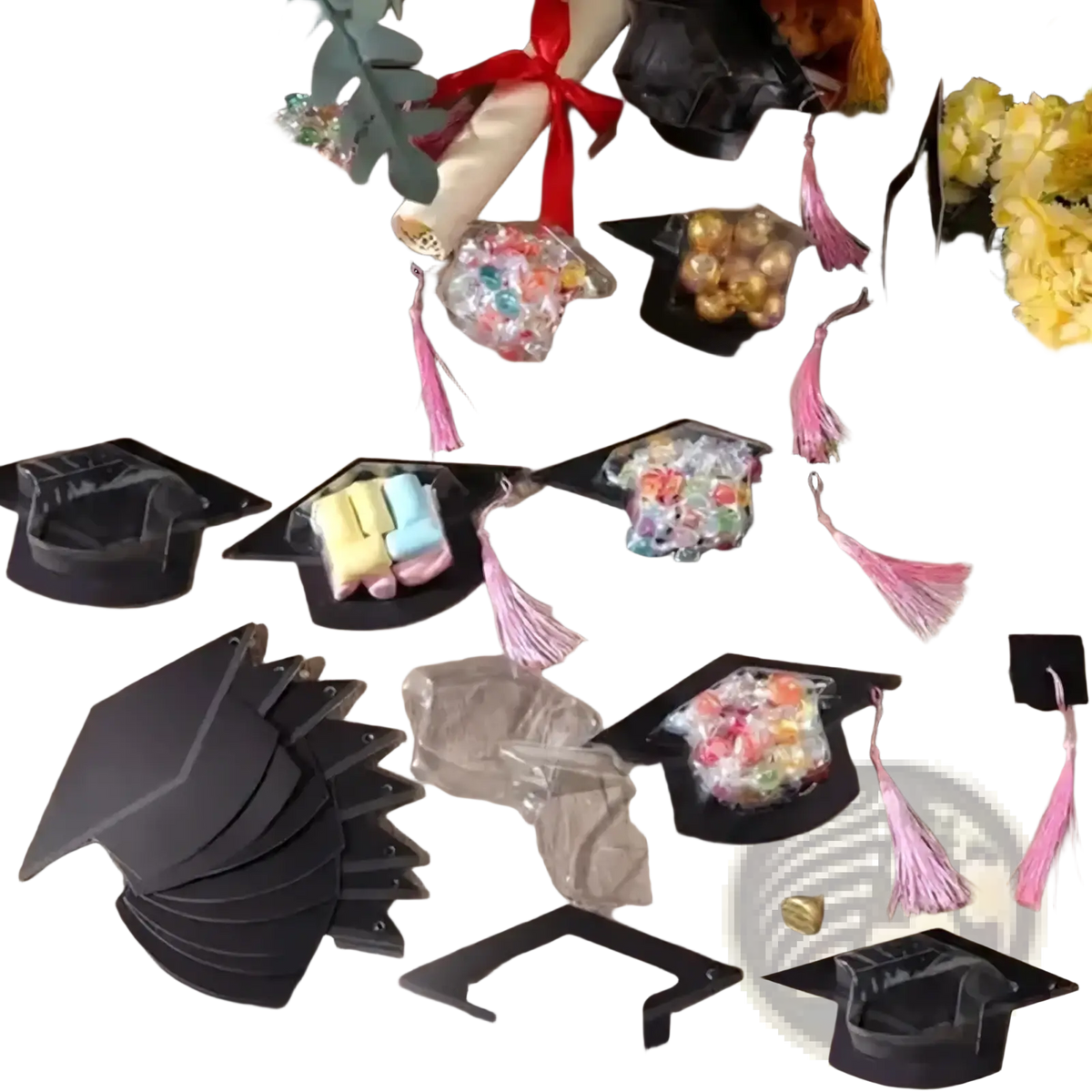 Black graduation cap candy holders with pink tassels and clear bags filled with colorful candies for party favors
