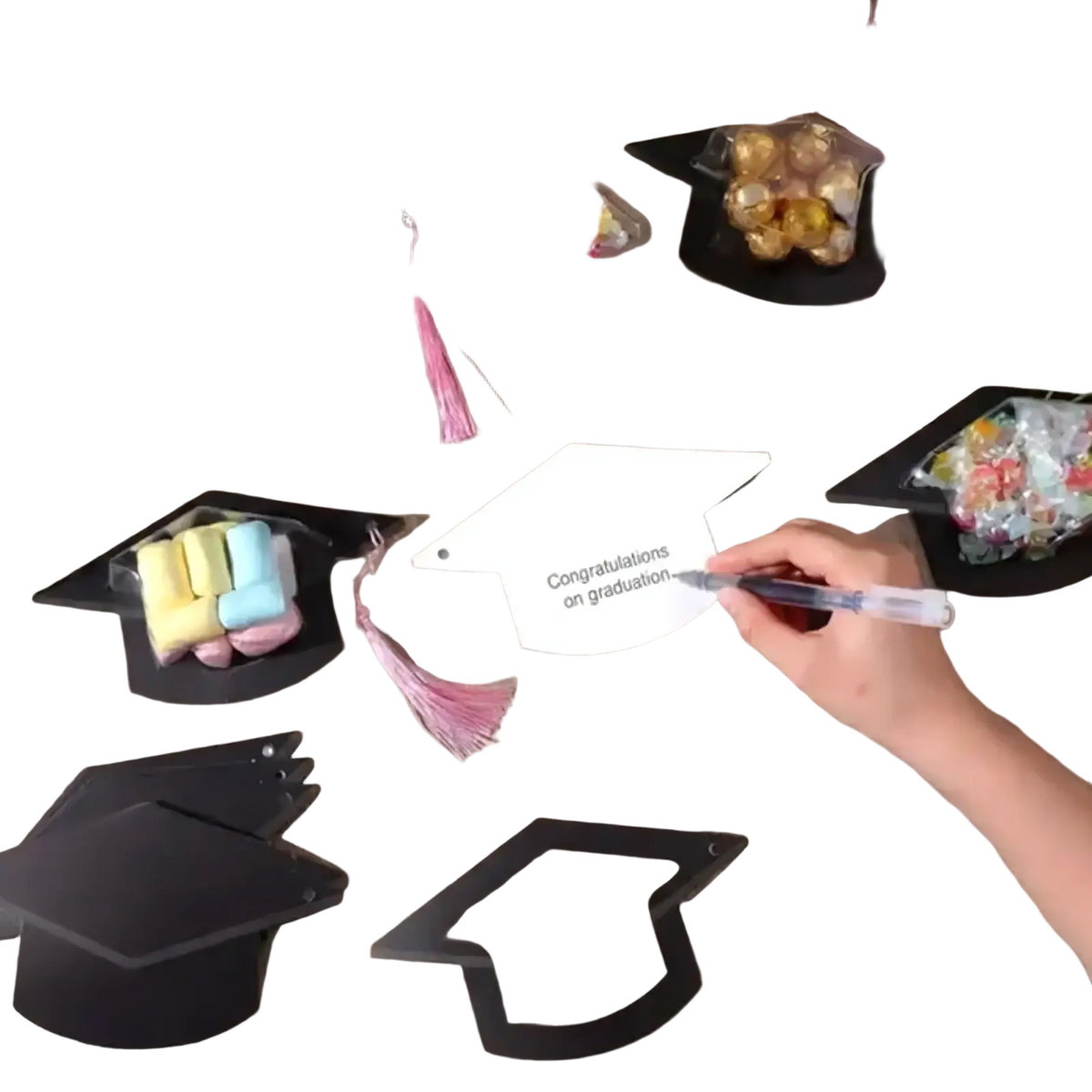 White graduation cap shaped paper card with congratulations on graduation printed in black ink for party favors