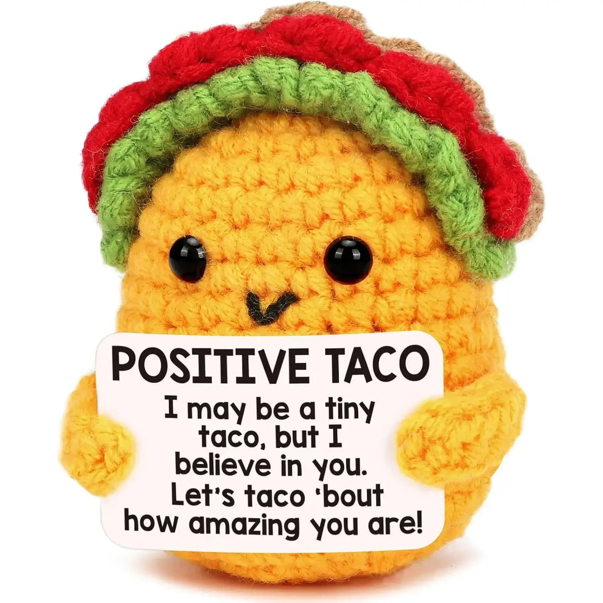 A crocheted orange taco plush toy with black button eyes wearing a red and green striped yarn hat for graduation gift