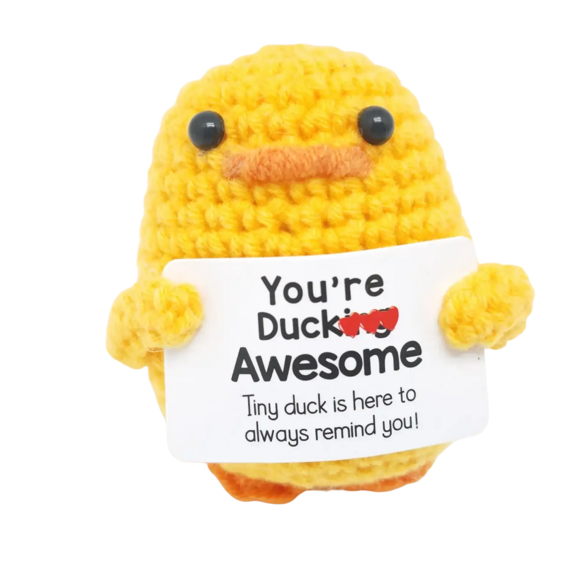 A yellow crocheted duck with black bead eyes and orange beak holding a white sign saying youre ducking awesome graduation gift 2025