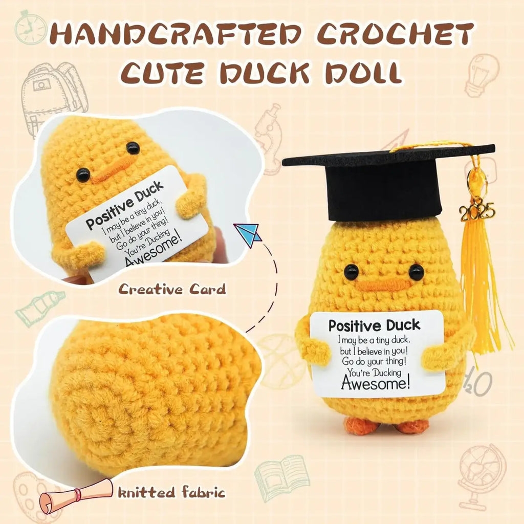 Yellow crocheted duck doll wearing a black graduation cap holding a white card labeled positive duck for Graduation 2025 gift