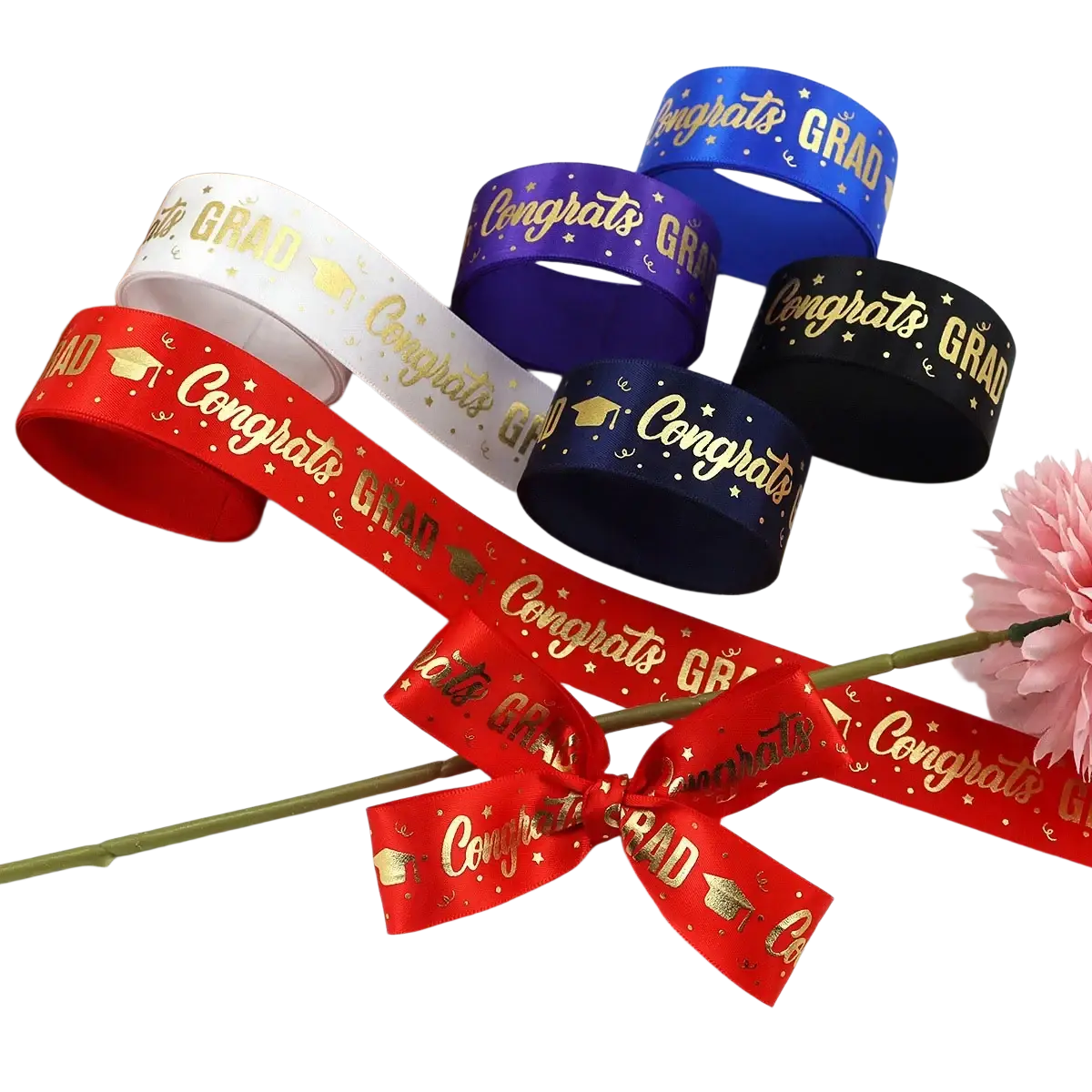 Red satin graduation gift wrapping ribbon featuring gold congrats grad text and cap motifs with small stars