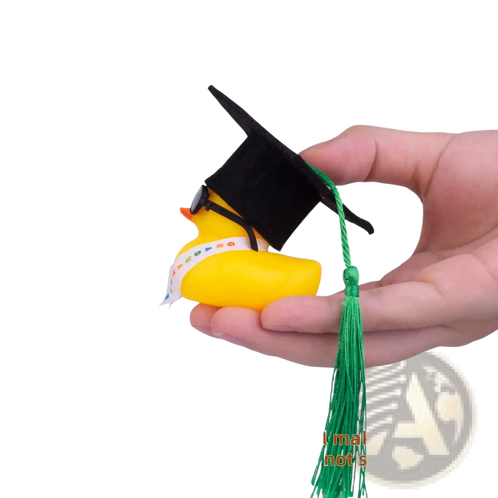 Yellow rubber graduation duck wearing a black cap with green tassel and sunglasses for celebration display